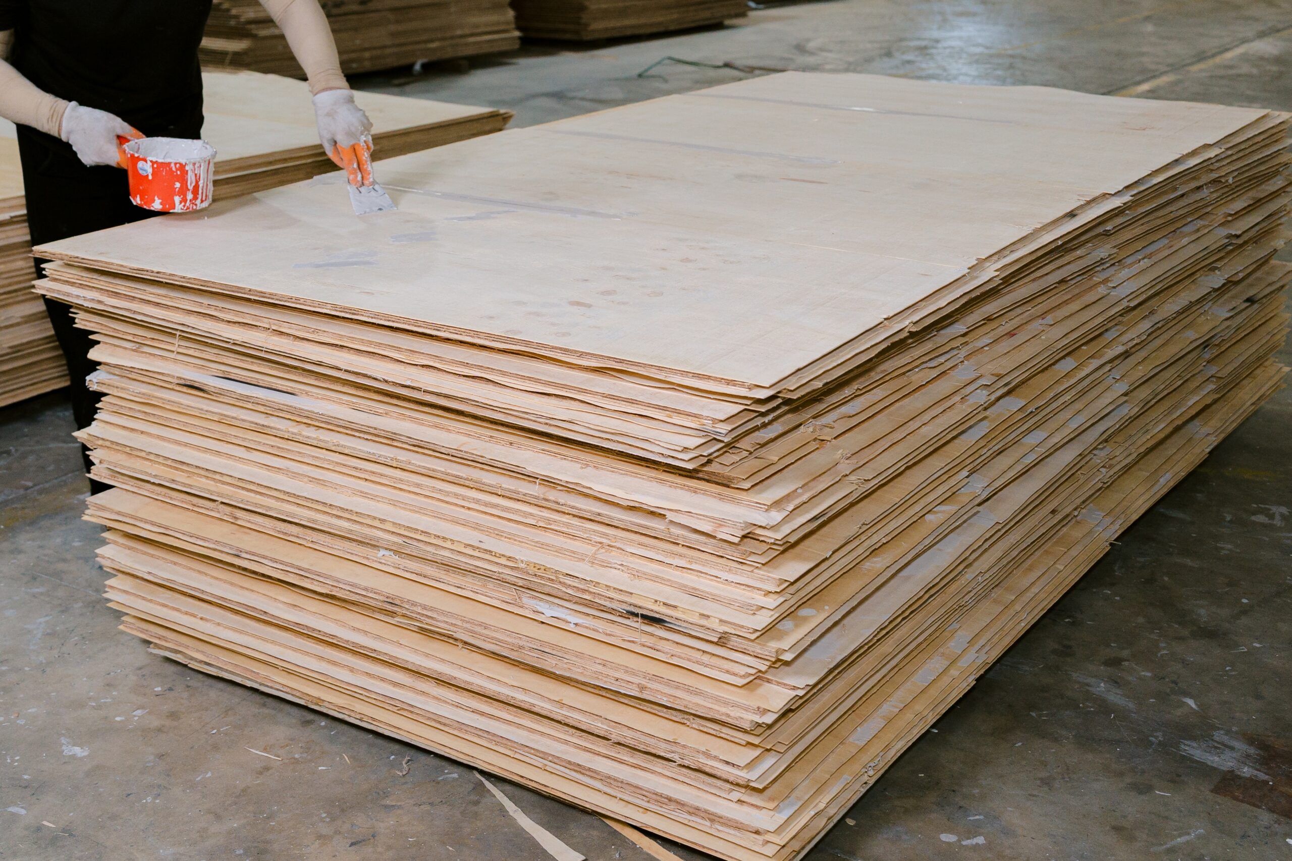 Stacked finished phenolic plywood panels ready for export at Kosmex Vietnam warehouse